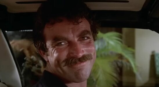 Tom Selleck as Thomas Magnum smiling while driving on Magnum P.I.