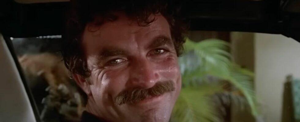 Tom Selleck as Thomas Magnum smiling while driving on Magnum P.I.