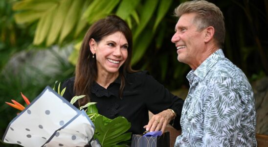 Theresa Nist holds a bouquet of flowers as she sits next to Gerry Turner on The Golden Bachelor Season 1.