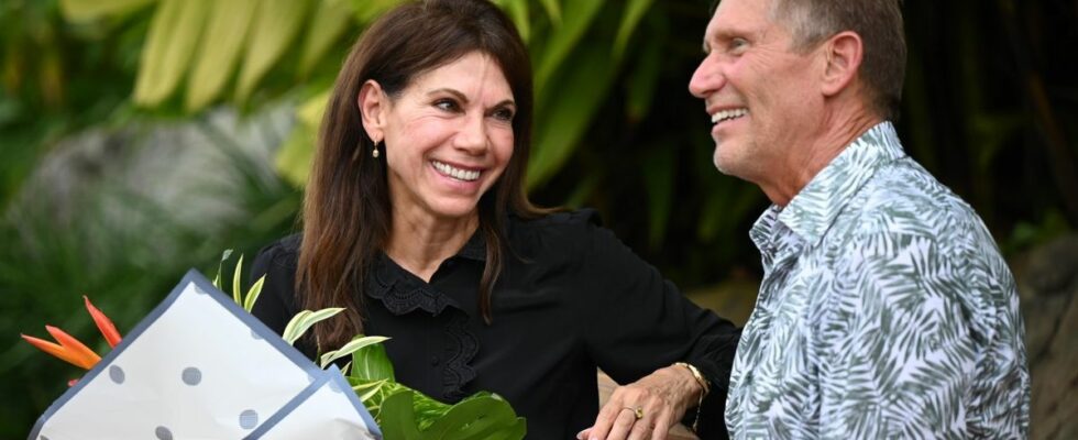 Theresa Nist holds a bouquet of flowers as she sits next to Gerry Turner on The Golden Bachelor Season 1.