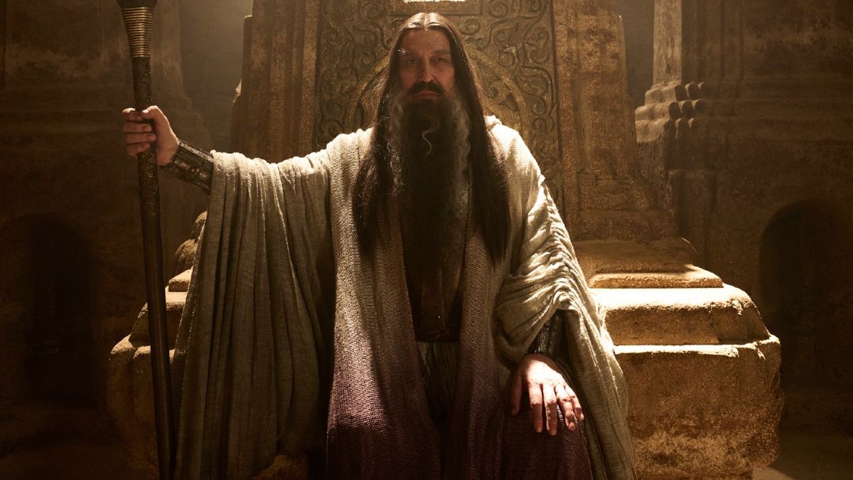 Ciarán Hinds as the &quot;Dark Wizard&quot; holding a staff.