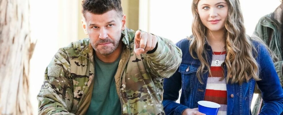 David Boreanaz as Jason Hayes and Kerri Medders as Emma Hayes standing next to each other and holding drinks on SEAL Team.