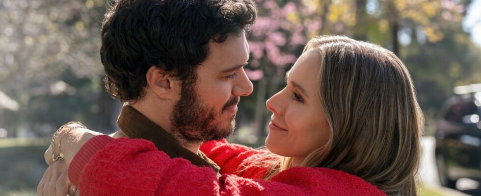 Adam Brody and Kristen Bell holding each other and looking longingly into each other's eyes.