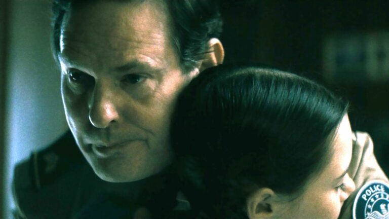 Henry Thomas holds his on-screen daughter in a hug in The Curse of the Necklace.