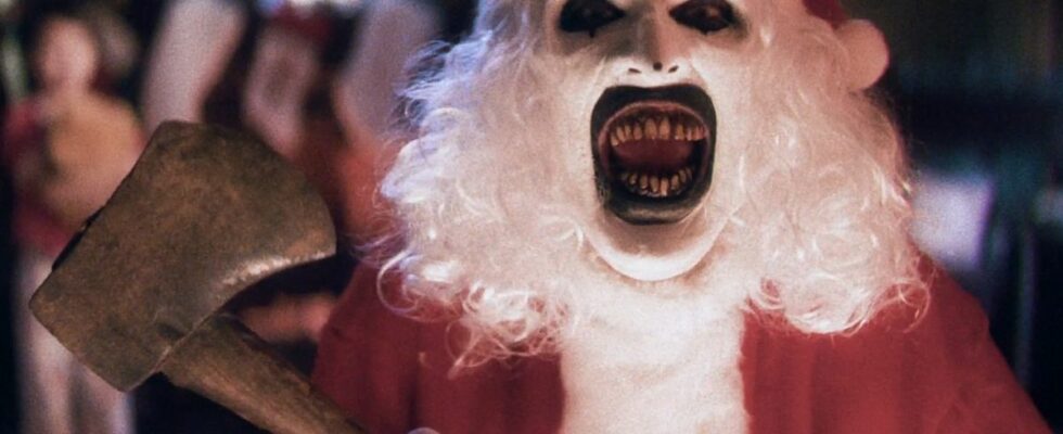 David Howard Thorton as Art the Clown, laughs while dressed as Santa with an axe, in Terrifier 3.