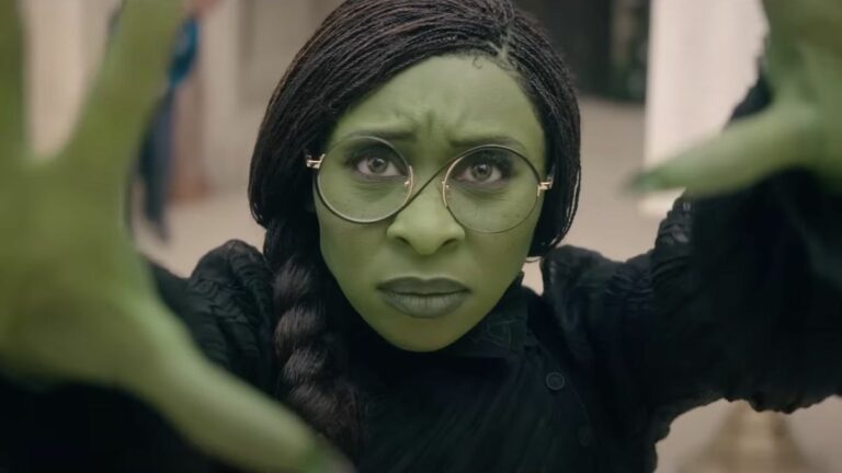 Cynthia Erivo's Elphaba holding up her hands in Wicked: Part One