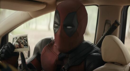 Close-up of Deadpool pointing to Polaroid picture of all of his friends in Deadpool &amp; Wolverine