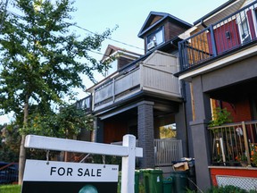 Une pancarte « à vendre » est affichée devant une maison dans le quartier de Riverdale, à Toronto, en Ontario.