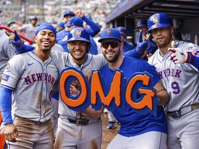 Francisco Lindor, à gauche, des Mets de New York, Jose Iglesias, au centre gauche, David Peterson, au centre droit, et Brandon Nimmo, à droite, célèbrent dans l'abri après avoir pris la tête du huitième repas d'un match de baseball contre les Braves d'Atlanta, lundi, Le 30 septembre 2024, à Atlanta.